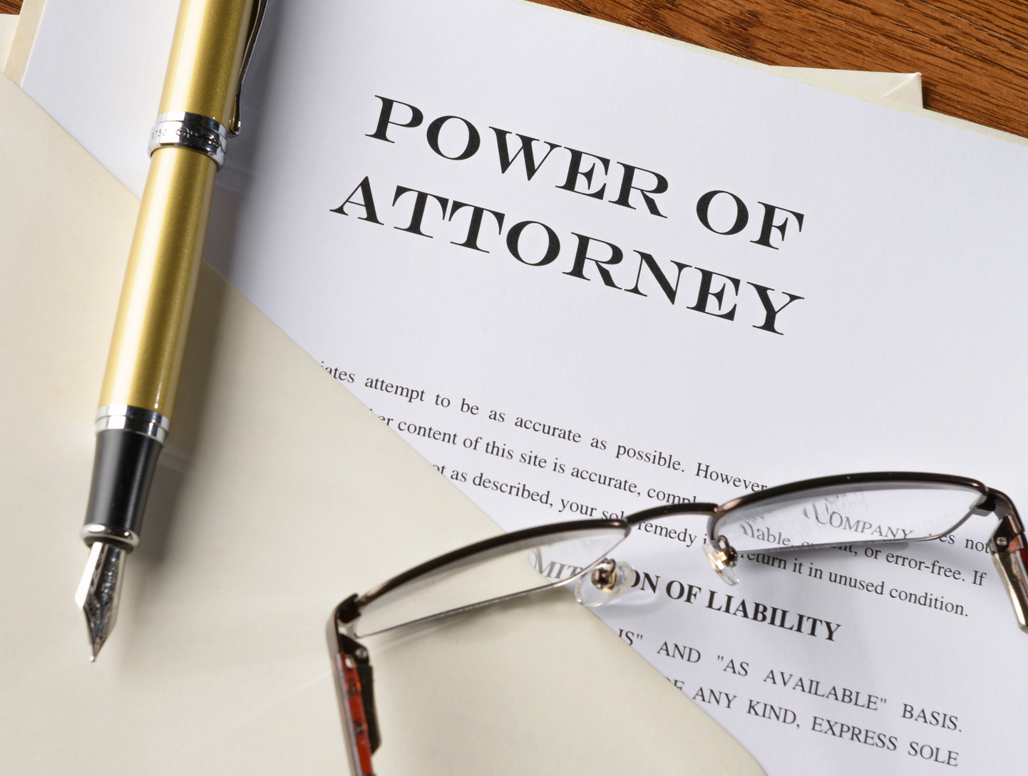 power of attorney document with pen and glasses